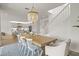 Bright dining area with wooden table and chairs leading into the kitchen and staircase at 3541 Great Banyan Way, Wesley Chapel, FL 33543
