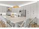 Spacious, modern kitchen with white cabinets, a large island, pendant lights, and stainless steel appliances at 3541 Great Banyan Way, Wesley Chapel, FL 33543