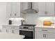 Well-equipped kitchen featuring stainless steel appliances, white subway tile backsplash, and white cabinets at 3541 Great Banyan Way, Wesley Chapel, FL 33543