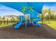 Vibrant community playground with slides and climbing structures under a blue shade canopy at 3541 Great Banyan Way, Wesley Chapel, FL 33543