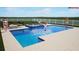 Resort-style pool with lounge area, spa, and beautiful clear blue water at 3541 Great Banyan Way, Wesley Chapel, FL 33543