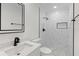 Modern bathroom with dark fixtures, white walls, and shower with marble-patterned tile at 3552 Middletown St, Port Charlotte, FL 33952