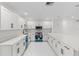 Well-lit kitchen features modern white cabinetry, stainless appliances, and a functional layout for culinary enthusiasts at 3552 Middletown St, Port Charlotte, FL 33952