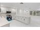 Modern kitchen boasting white cabinets, quartz countertops, stainless steel appliances, and open-concept design at 3552 Middletown St, Port Charlotte, FL 33952