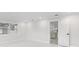 Cozy room showcases fresh paint, white trim and a doorway leading into the beautifully updated kitchen at 3552 Middletown St, Port Charlotte, FL 33952