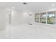 Spacious living room with large windows, white paint and a modern feel thanks to the new floors and recessed lights at 3552 Middletown St, Port Charlotte, FL 33952