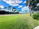 Expansive backyard view featuring a well-manicured lawn and clear blue sky at 3725 Teeside Dr, New Port Richey, FL 34655