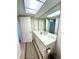 Clean bathroom featuring a single vanity, large mirror, and ample lighting, providing a functional space at 3725 Teeside Dr, New Port Richey, FL 34655