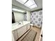 Bathroom with a vanity, toilet and shower featuring a pattern shower curtain, complimented by a neutral patterned rug at 3725 Teeside Dr, New Port Richey, FL 34655