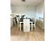 Dining room with laminate flooring, a dark wood table with light colored chairs at 3725 Teeside Dr, New Port Richey, FL 34655
