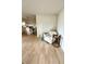 Inviting living space featuring wood-look flooring, neutral color palette, and ample natural light at 3725 Teeside Dr, New Port Richey, FL 34655