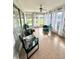 Sunroom with tile floors and large windows, perfect for enjoying indoor-outdoor living with lots of natural light at 3725 Teeside Dr, New Port Richey, FL 34655