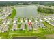 Aerial view of a modern neighborhood featuring a tranquil lake and well-maintained homes at 3816 N Maryland Ave, Plant City, FL 33565