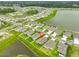 Aerial view of a modern home in a Primary-planned community with lakes and green spaces at 3816 N Maryland Ave, Plant City, FL 33565