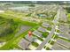 Aerial view of a residential community featuring modern homes, community pool, and serene water views at 3816 N Maryland Ave, Plant City, FL 33565