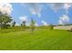 Picture of a well-maintained green backyard with a view of a peaceful pond at 3816 N Maryland Ave, Plant City, FL 33565