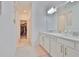 Elegant bathroom featuring dual sinks, quartz countertops, and a walk-in closet at 3816 N Maryland Ave, Plant City, FL 33565