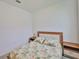 Bedroom with floral bedding, wood side tables, and neutral walls, offering a cozy and inviting space at 3816 N Maryland Ave, Plant City, FL 33565