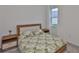 This bedroom offers a bed with floral covers and wood accents, side tables, and a window at 3816 N Maryland Ave, Plant City, FL 33565