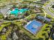 Aerial view of a community pool, playground, basketball and tennis courts at 3816 N Maryland Ave, Plant City, FL 33565