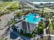 Aerial view of a community pool with palm trees, blue water and a clubhouse at 3816 N Maryland Ave, Plant City, FL 33565