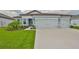 Charming single-story home featuring a three-car garage, lush lawn, and well-manicured landscaping at 3816 N Maryland Ave, Plant City, FL 33565
