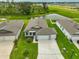 Aerial view of a one-story home with a well-manicured lawn and three car garage at 3816 N Maryland Ave, Plant City, FL 33565