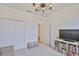 Living room features a closet, an open doorway to the hall, a television, and a bookcase at 3816 N Maryland Ave, Plant City, FL 33565