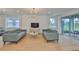 Spacious living room with dual sofas, a view to the outside patio, and modern fixtures at 3816 N Maryland Ave, Plant City, FL 33565