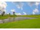 Picturesque pond surrounded by green grass and landscaping at 3816 N Maryland Ave, Plant City, FL 33565