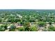 Find a home with a red pin nestled among lush greenery in a vibrant residential neighborhood from an aerial vantage point at 4028 Queen N St, St Petersburg, FL 33714