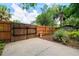 Private backyard features wood fence, concrete patio, mature landscaping, and bird bath for a relaxing outdoor retreat at 4028 Queen N St, St Petersburg, FL 33714