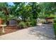 Expansive backyard with lush landscaping, shed, driveway, patio, and a wooden fence surrounding the perimeter at 4028 Queen N St, St Petersburg, FL 33714