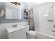 A cozy bathroom with a tub and shower, a sink with modern vanity, and neutral decor at 4028 Queen N St, St Petersburg, FL 33714