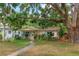 Charming one-story home with mature trees and lush landscaping at 4028 Queen N St, St Petersburg, FL 33714