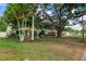 Beautiful front yard with mature trees, providing ample shade and curb appeal at 4028 Queen N St, St Petersburg, FL 33714