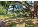 Charming single story home with a well-manicured lawn and mature shade trees at 4028 Queen N St, St Petersburg, FL 33714