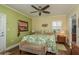 Comfortable bedroom with wood floors, ceiling fan, shuttered windows, and neutral decor at 4516 Seagull Dr # 601, New Port Richey, FL 34652
