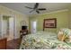 Inviting bedroom featuring wood floors, ceiling fan, and a private balcony with scenic views at 4516 Seagull Dr # 601, New Port Richey, FL 34652