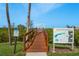 Scenic view of community dock near informational signage, providing an access to recreational boating activities at 4516 Seagull Dr # 601, New Port Richey, FL 34652
