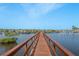 Straight view of the community dock and boat slips over blue water under a clear blue sky at 4516 Seagull Dr # 601, New Port Richey, FL 34652