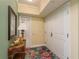 Condo hallway decorated with small table, mirror, and nice lamps at 4516 Seagull Dr # 601, New Port Richey, FL 34652