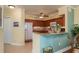 Bright kitchen featuring granite countertops, wood cabinets, modern appliances, and breakfast bar at 4516 Seagull Dr # 601, New Port Richey, FL 34652