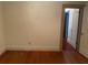 Simple bedroom featuring hardwood floors, an electrical outlet, and doorway to an adjoining room at 4526 Burlington N Ave, St Petersburg, FL 33713