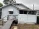 Exterior back view of home featuring wood porch and lattice at 4526 Burlington N Ave, St Petersburg, FL 33713