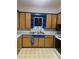 A full view of the vintage style kitchen with custom blue cabinets and white appliances at 4526 Burlington N Ave, St Petersburg, FL 33713
