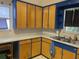 A close-up view of the vintage kitchen, highlighting the countertops and custom blue cabinets at 4526 Burlington N Ave, St Petersburg, FL 33713
