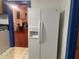 A kitchen view looking into the living room with a large refrigerator in the foreground at 4526 Burlington N Ave, St Petersburg, FL 33713