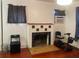 Living room with hardwood floors, decorative fireplace, and plenty of natural light at 4526 Burlington N Ave, St Petersburg, FL 33713