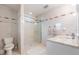 Bathroom with a walk-in shower, toilet, sink and vanity with marble countertops at 475 Holly Hill Rd, Oldsmar, FL 34677